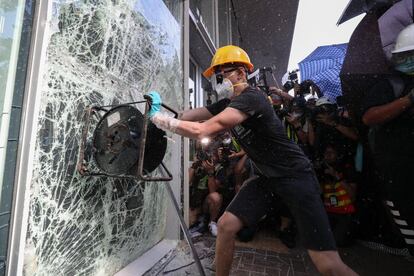 Un manifestante intenta rompe una cristalera del Parlamento en Hong Kong, este lunes.