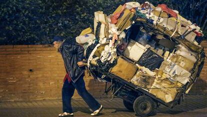 A man pulling a cart in Barcelona.