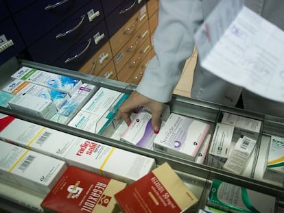 Una farmacèutica cerca un medicament.