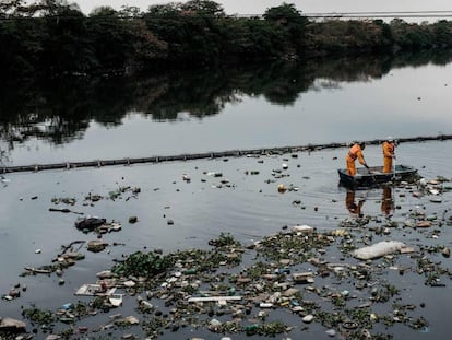 O eco-barcos recolhem os vertidos que se têm colado pela barreira na baía de Guanabara.