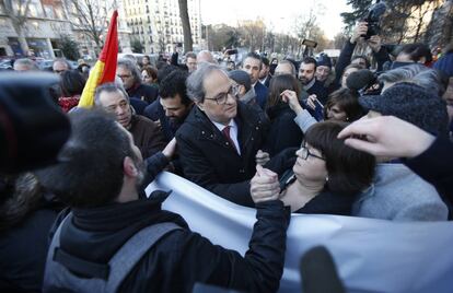 Catalan premier Quim Torra is greeted by pro-independence protesters in the Paseo del Prado boulevard in Madrid.