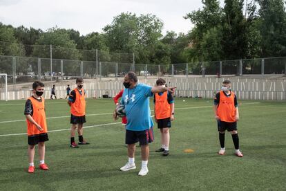 Un entrenador da instrucciones a sus jugadores durante el entrenamiento de infantiles del Santiago Apóstol.