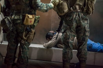 Chilean soldiers arrest a young man they found after the curfew, in Osorno, during the social unrest of 2019.