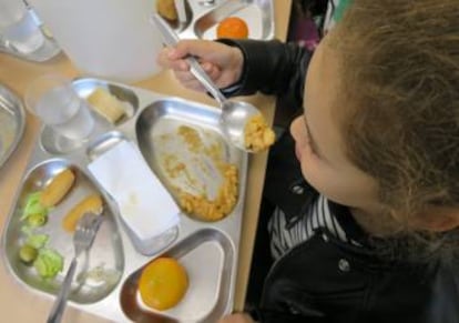 Una niña en un comedor escolar.