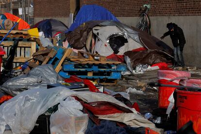 City workers and volunteers remove the tents and belongings from the 'Mass and Cass' homeless encampment as the city attempts to find housing alternatives in Boston, Massachusetts, January 12, 2022.