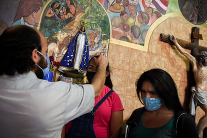 El padre Facundo Ribero bendice a Raizza y a Angie en la Iglesia Virgen de los Milagros de Caacupé, villa 22-24, en Barracas, Buenos Aires (Argentina). Para ver la fotogalería completa, pincha en la imagen.