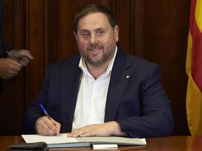 El vicepresidente Oriol Junqueras firma la convocatoria de referéndum tras la aprobación en el Parlament.