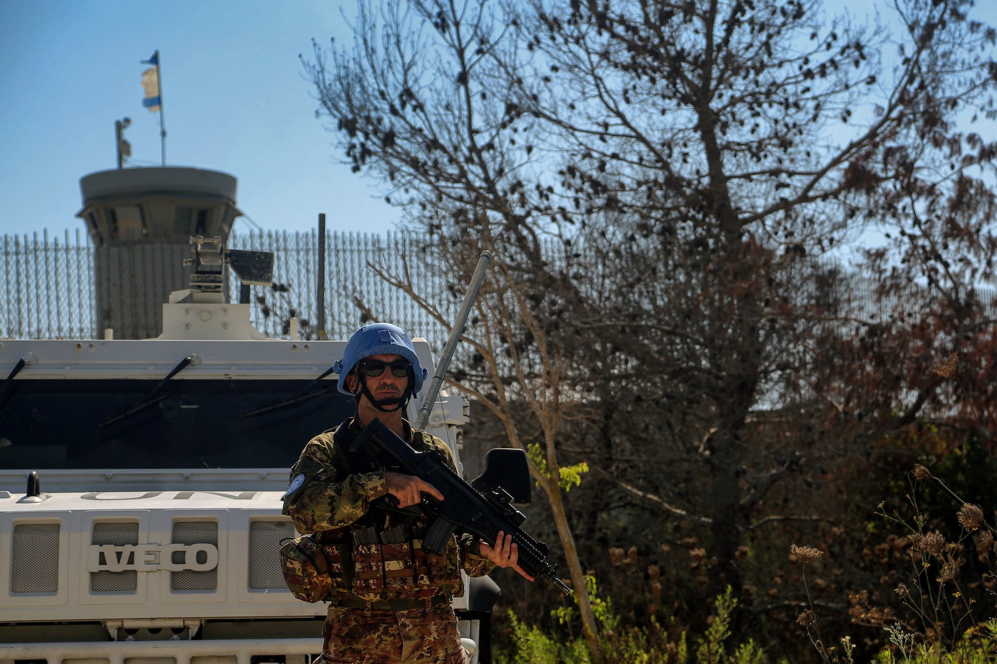 09 September 2024, Lebanon, Aalma El Chaeb: A UN Italian peacekeeping soldier secures an area outside his base in the southern Lebanese border village of Aalma El Chaeb, where part of an Israeli flag is seen fluttering over a post on the other side of the border. Pro-Iranian Hezbollah and Israeli forces trade missiles across the border. Photo: Marwan Naamani/dpa (Photo by Marwan Naamani/picture alliance via Getty Images)