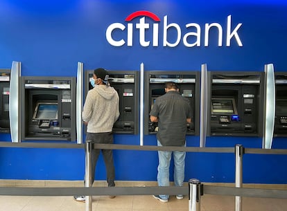 Customers use ATMs at Citibank