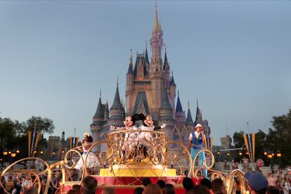 Mickey and Minnie Mouse perform during a parade as they pass by the Cinderella Castle at the Magic Kingdom theme park at Walt Disney World in Lake Buena Vista, Fla.