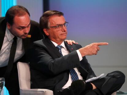 Carlos Bolsonaro, concejal y estratega digital del clan familiar, junto a su padre en uno de los debates presidenciales, en Río, en septiembre de 2022.