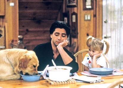 John Stamos as Jesse, next to one of the Olsen sisters, in her role as Michelle, in the show 'Full House.'