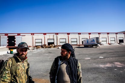 Two rebel fighters guard the former captagon laboratory near Douma.