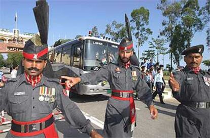 Un autobús de pasajeros de la línea Nueva Delhi-Lahore cruza la frontera indo-paquistaní bajo protección policial.