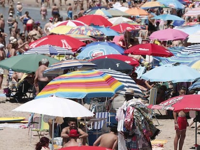 Numerosos bañistas disfrutan del sol y la playa en la playa de Cullera, Valencia.