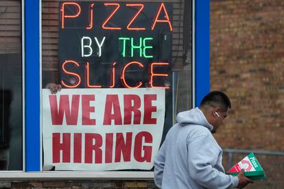 A hiring sign is displayed at a restaurant in Prospect Heights, Ill., Tuesday, April 4, 2023. On Friday, the U.S. government issues the March jobs report.