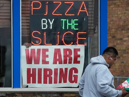 A hiring sign is displayed at a restaurant in Prospect Heights, Ill., Tuesday, April 4, 2023. On Friday, the U.S. government issues the March jobs report.