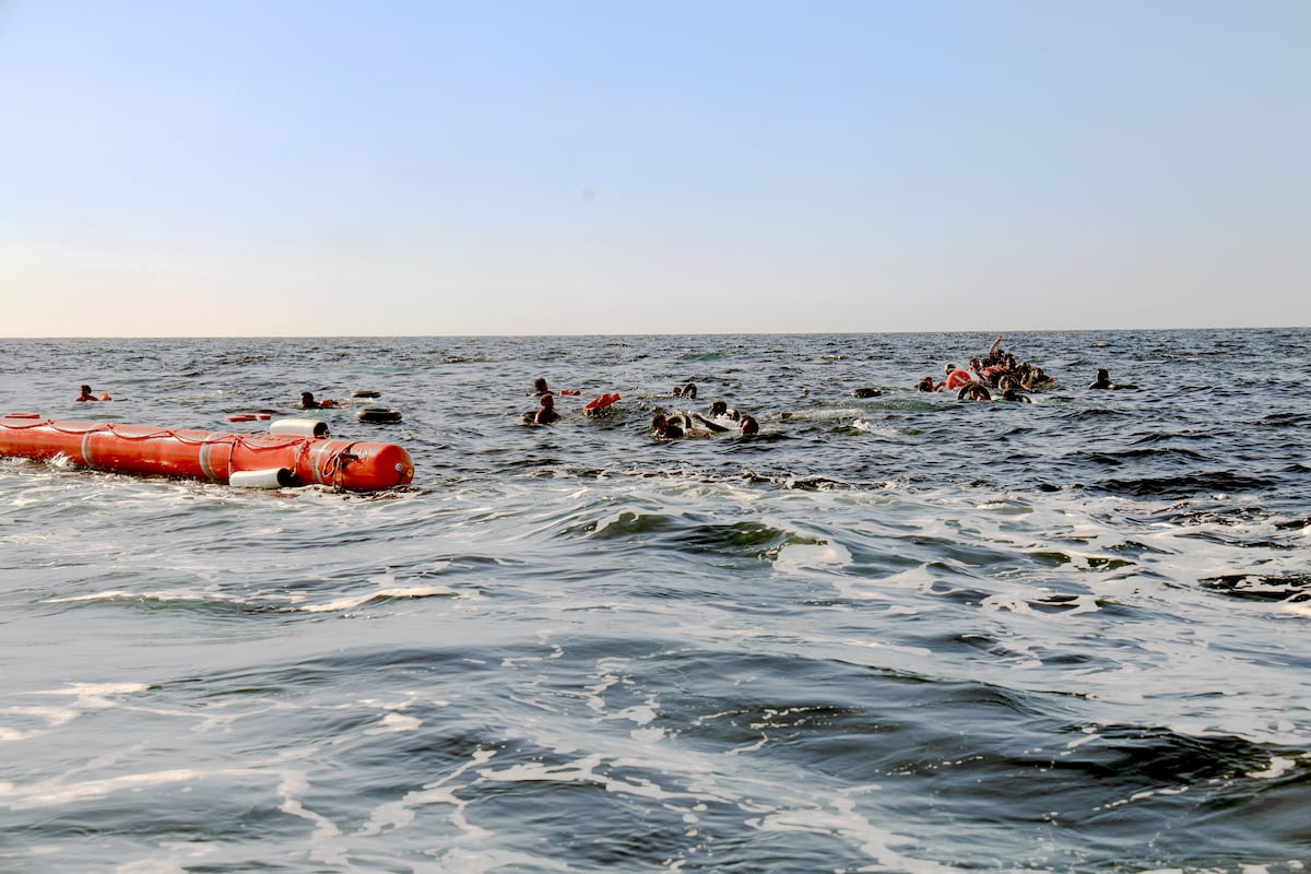 A Libyan boat shoots apart migrant families on a boat about to sink in the Mediterranean