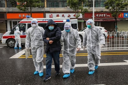 Miembros del personal médico acompañan a un paciente a un hospital en Wuhan (China), epicentro del brote de coronavirus.