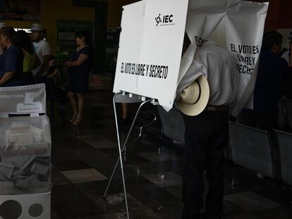 Un hombre vota en una casilla electoral en México en las elecciones intermedias de 2021.