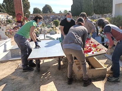 Un grupo de personas levanta una lápida en el cementerio de Paterna (Valencia), el pasado 21 de abril.