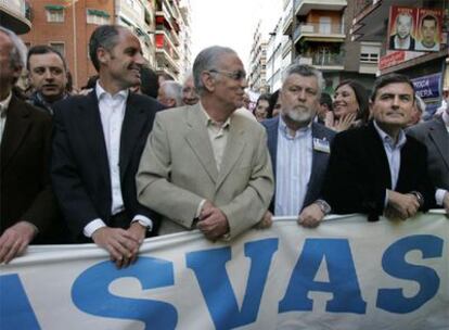 El presidente Francisco Camps y el líder socialista, Jorge Alarte, ayer, tras la misma pancarta en la manifestación de Murcia.
