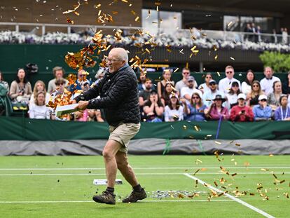 Un activista vierte confeti naranja sobre una de las pistas, este miércoles en Wimbledon