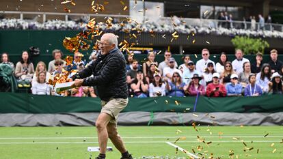 Un activista vierte confeti naranja sobre una de las pistas, este miércoles en Wimbledon