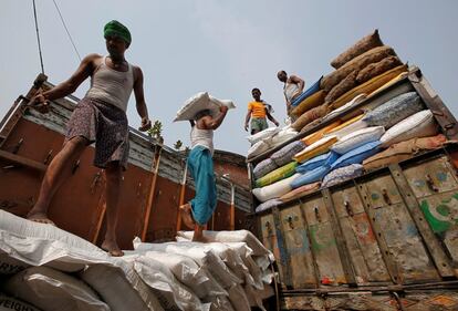 Un trabajador carga un saco de azúcar en un camión que se dirige al mercado mayorista de Calcuta (India).