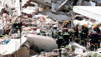 Fire fighters at the site of the collapse on Thursday.