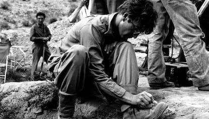 John Lennon draws on his boots during the filming of "How I won the war"