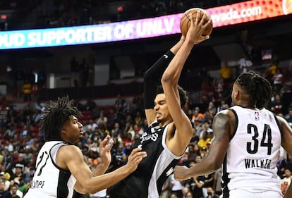 San Antonio Spurs' Victor Wembanyama (C) controls the ball during the NBA Summer League game between the San Antonio Spurs and Portland Trail Blazers, at the Thomas and Mack Center in Las Vegas, Nevada, on July 9, 2023.