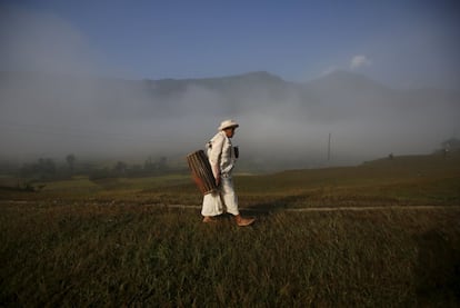 A priest carrying a traditional musical instrument arrives to perform rituals during the Shikali festival at Khokana village in Lalitpur, Nepal October 19, 2015. Dressed with colourful clay masks, the mediums participate in dances while villagers offer sacrificed animals and prayers in hope of gaining blessing from the deities in the annual Shikali festival. REUTERS/Navesh Chitrakar