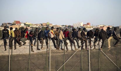 Inmigrantes encaramados en la valla de Melilla.