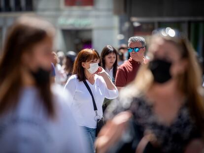 Grupo de personas con y sin mascarillas por el centro de Madrid.