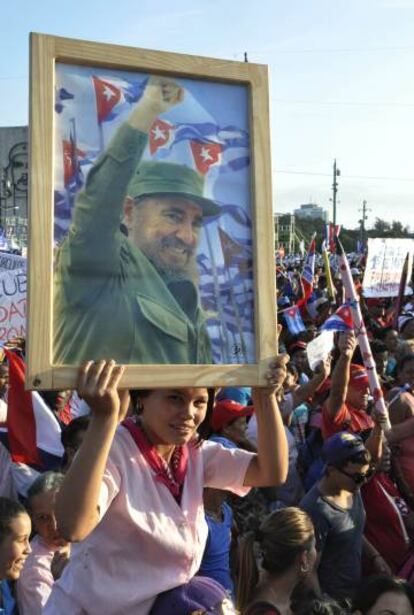 Una mujer sostiene un retrato de Fidel Castro durante el desfile del 1 de mayo.