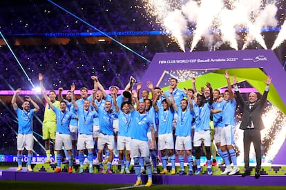 Manchester City's Kyle Walker, center, lifts the trophy at the end of the Soccer Club World Cup final match between Manchester City FC and Fluminense FC at King Abdullah Sports City Stadium in Jeddah, Saudi Arabia. Dec. 22, 2023.