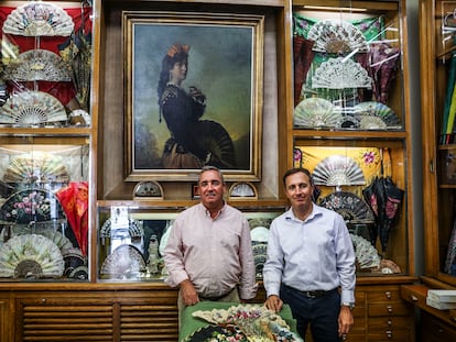 Javier y Arturo Llerandi posan junto al cuadro de Agustín Segura inspirado en su abuela que preside la tienda de abanicos Casa de Diego, fundada en 1823, en Madrid.