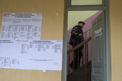 Un home puja les escales després d'haver votat en una mesa electoral en una escola de primària a Atenes.