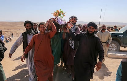 People bury a victim in earthquake-hit Zinda Jan district of Herat, Afghanistan