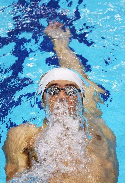 El estadounidense Michael Phelps, ganador de ocho medallas de oro en Pekín 2008, nada a espalda durante los 400m estilos individual.