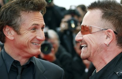 President of the Jury Penn and singer Bono arrive for the screening of "Un Conte de Noel" in Cannes