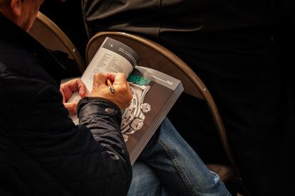 One of the attendees at the Geneva auction takes notes on the catalogue.