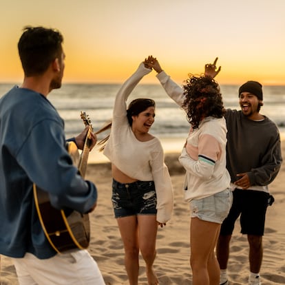 Friends dancing and having fun on the beach
