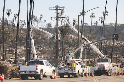 Power utility workers in the area burnt down on the beachside road in Pacific Palisades.
