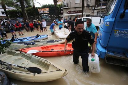 Locals in Dolores wait for supplies after the Segura river overflowed, submerging thousands of hectares of flat agricultural land.