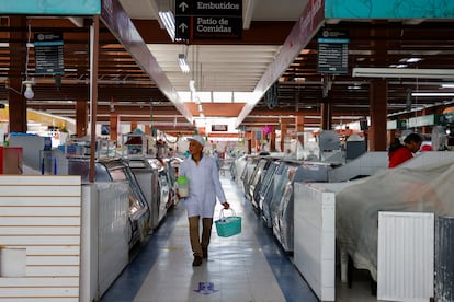 A man shopping for produce in an almost empty market in Quito on January 10.