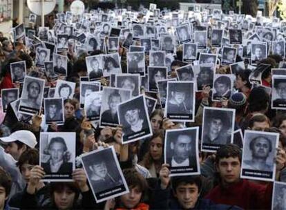 Manifestantes muestran fotografías de las víctimas del atentado contra la AMIA en el 14º aniversario del ataque, el viernes en Buenos Aires.