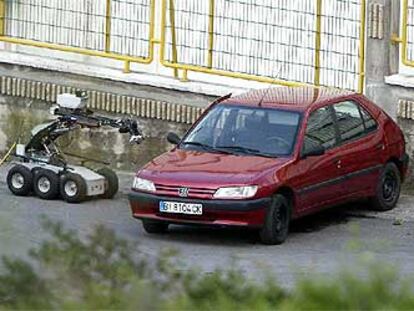 El coche cargado con la bomba trampa, junto al robot de los artificieros, que no pudo ser utilizado.
