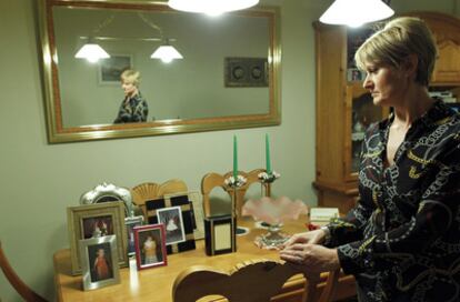 Ángeles González Carreño looks at photographs she keeps of her daughter Andrea.